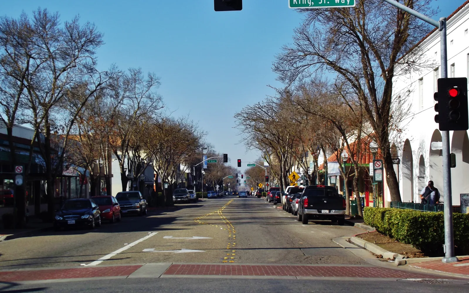 Historic downtown street with storefronts and trees in Merced, California